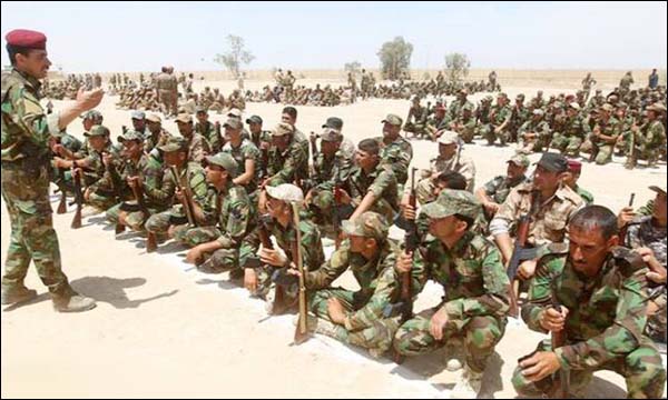مقاتلون في الحشد الشعبي يستمعون إلى تعليمات ضابط في الجيش